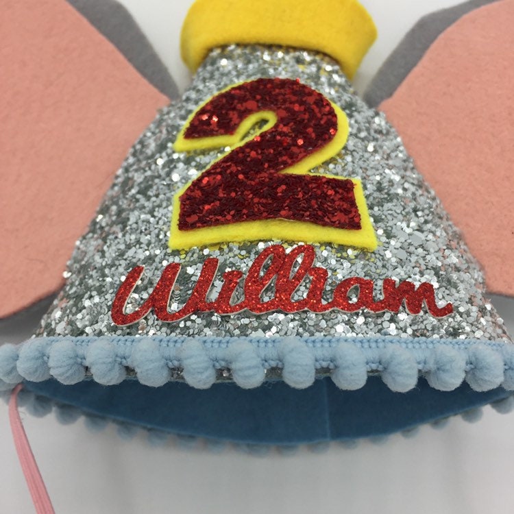 Silver and red Dumbo theme cone hat, red lettering